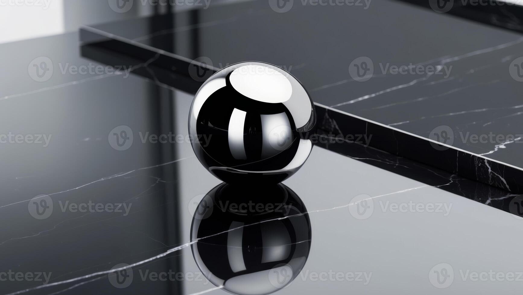 Reflective Sphere on a Black Marble Surface. photo