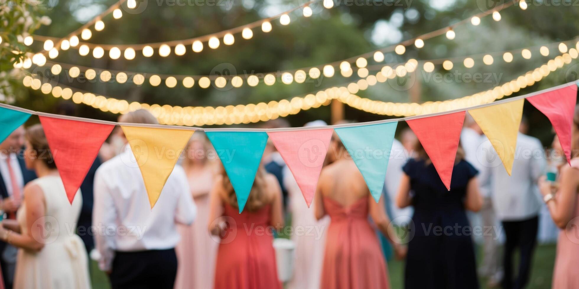 Colorful bunting is swaying in the breeze as string lights illuminate a festive backyard gathering. photo