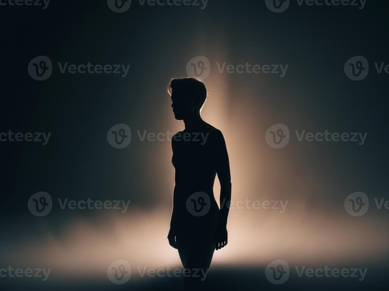 Silhouette of a performer on stage under bright stage lights at night. photo
