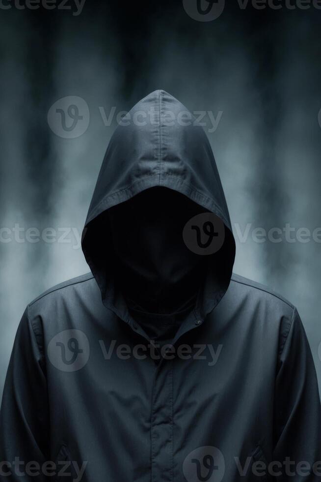 A hooded criminal or hacker is depicted with a dark silhouette in an ominous and faceless portrayal. photo
