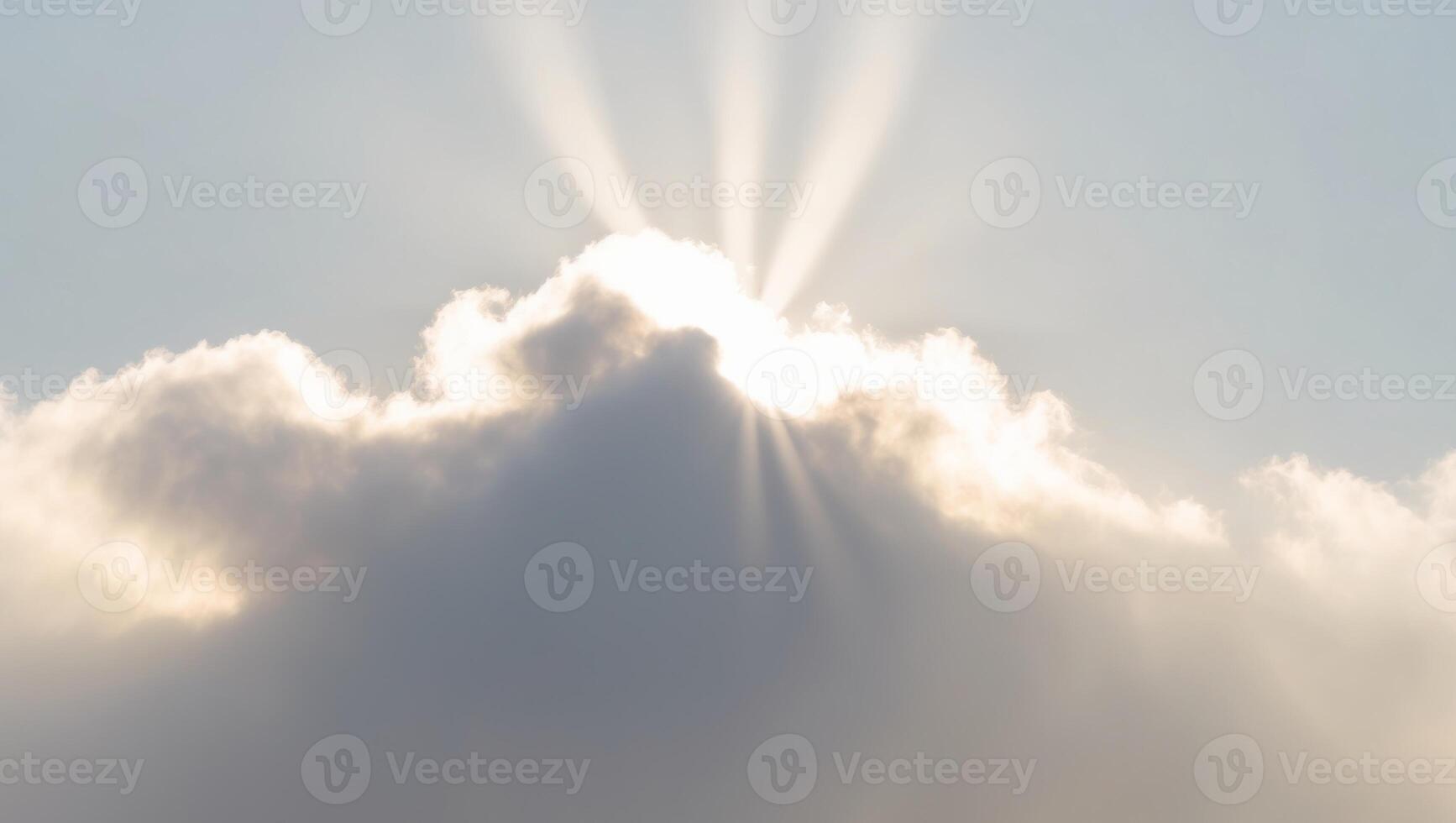 Solar energy concept with rays of sunlight breaking through cloud. photo