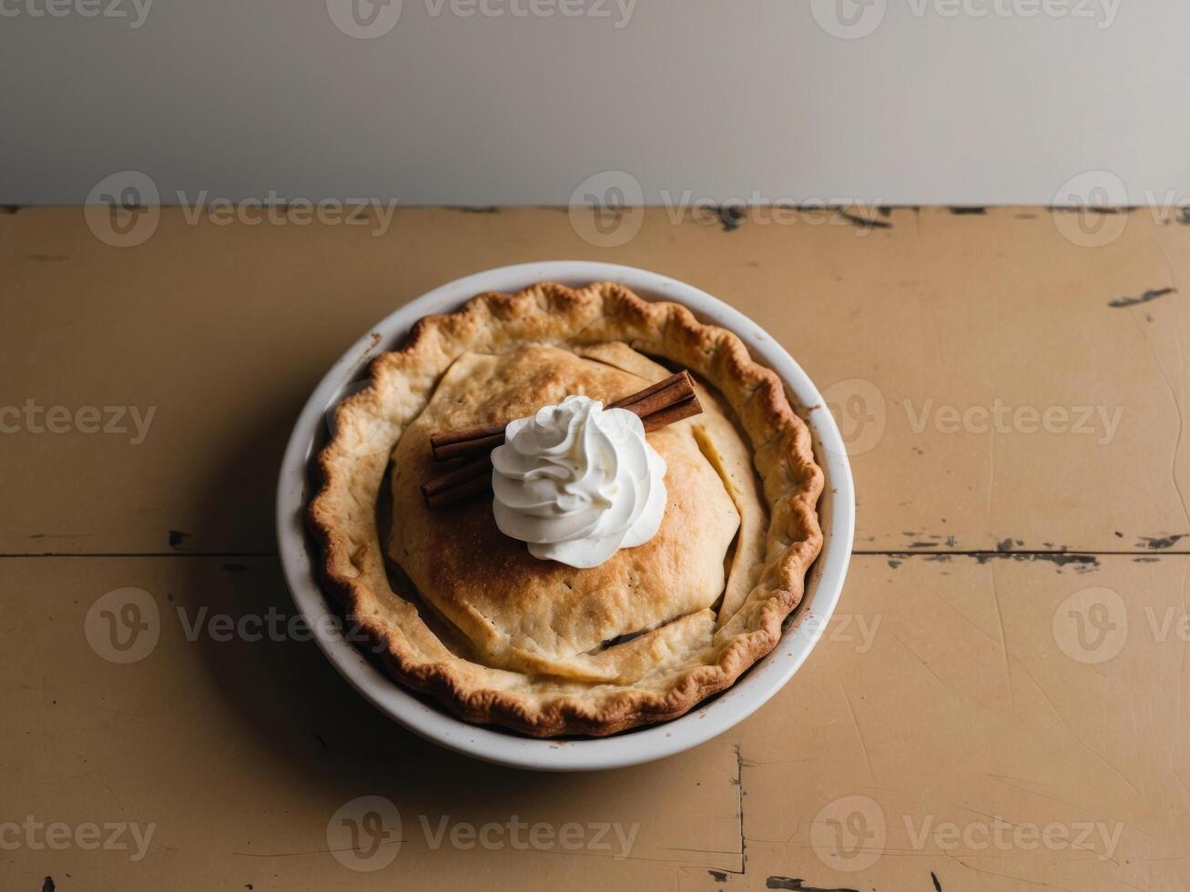 Golden Crust Apple Pie with Whipped Cream and Cinnamon Sticks on a Rustic Wooden Table. photo
