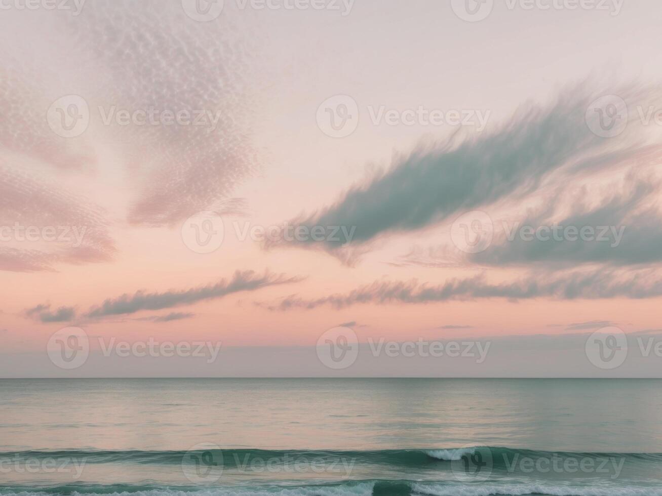 Pastel sunset sky with wispy clouds over calm ocean. photo
