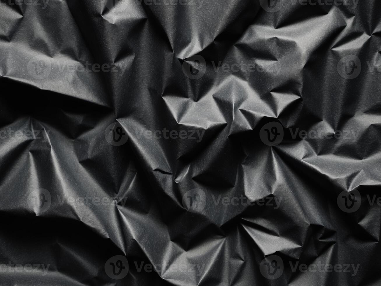 Textured Black Crumpled Paper Background for Abstract Designs. photo