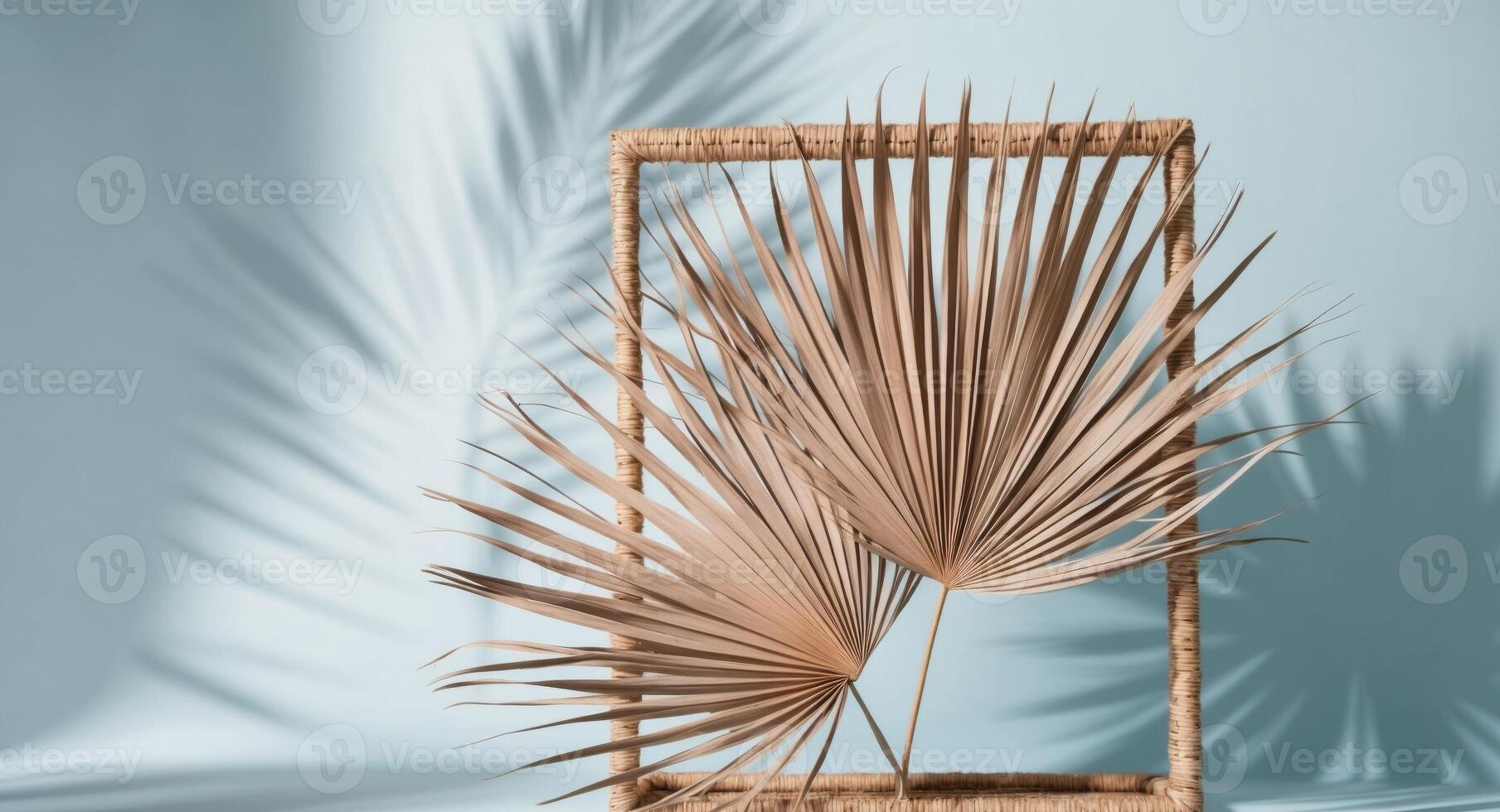 Dried Palm Leaves and Wicker Framing a Blue Background with Light Shadows. photo