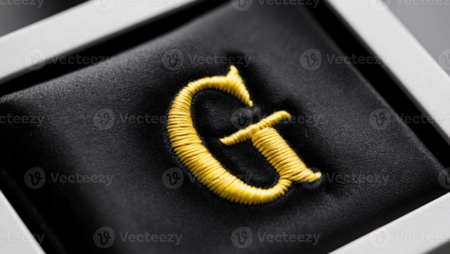 Close up of Machine Embroidery on Black Velvet Fabric with Yellow Thread - Embroidered Initial G. photo