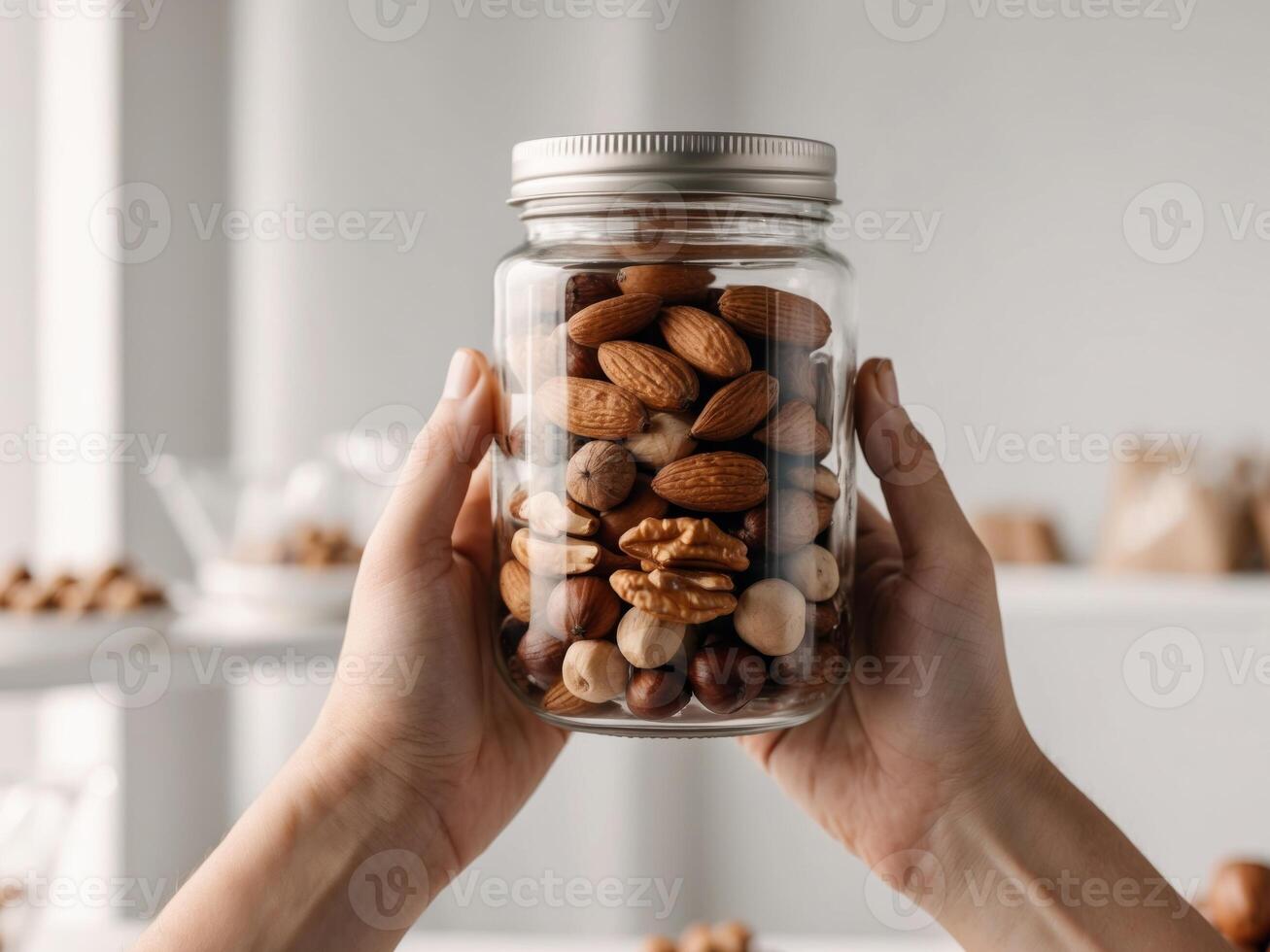 Hands holding a glass jar filled with nuts in a packaging free grocery with a blurry background. photo