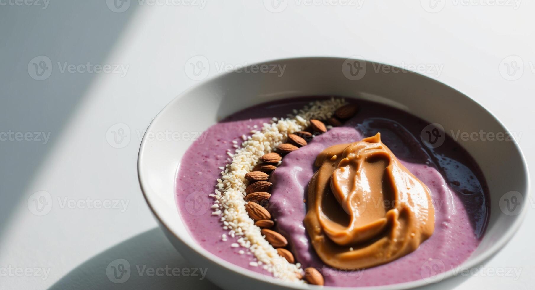 Protein packed smoothie bowl with almond butter closeup. photo