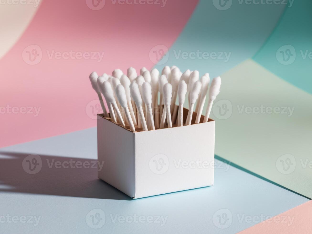 Cotton Buds in a Box on Colorful Background. photo