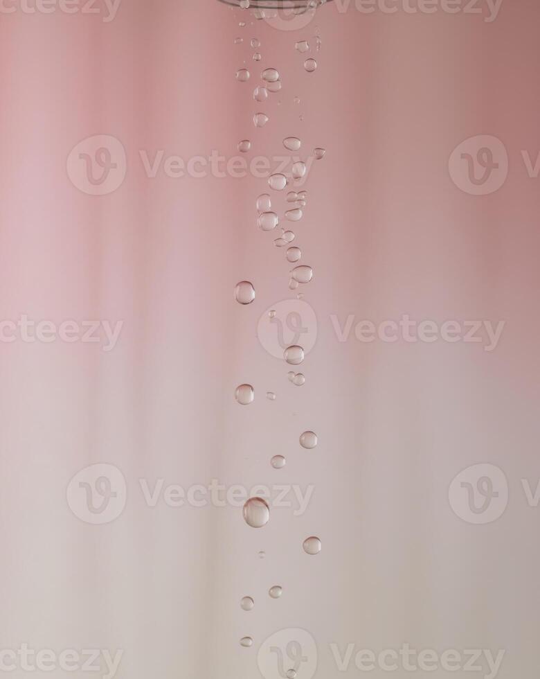 Elegant water droplets on a soft pink background. photo