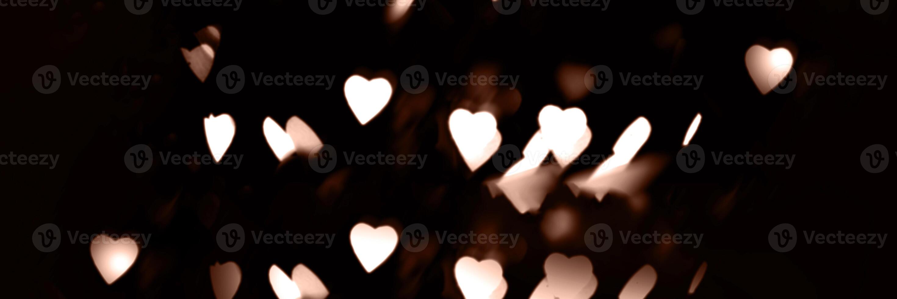 Blurry garland lights on a dark background. Festive Christmas and New Year background. Soft focus. Image toned in color of 2025 year - Mocha Mousse photo