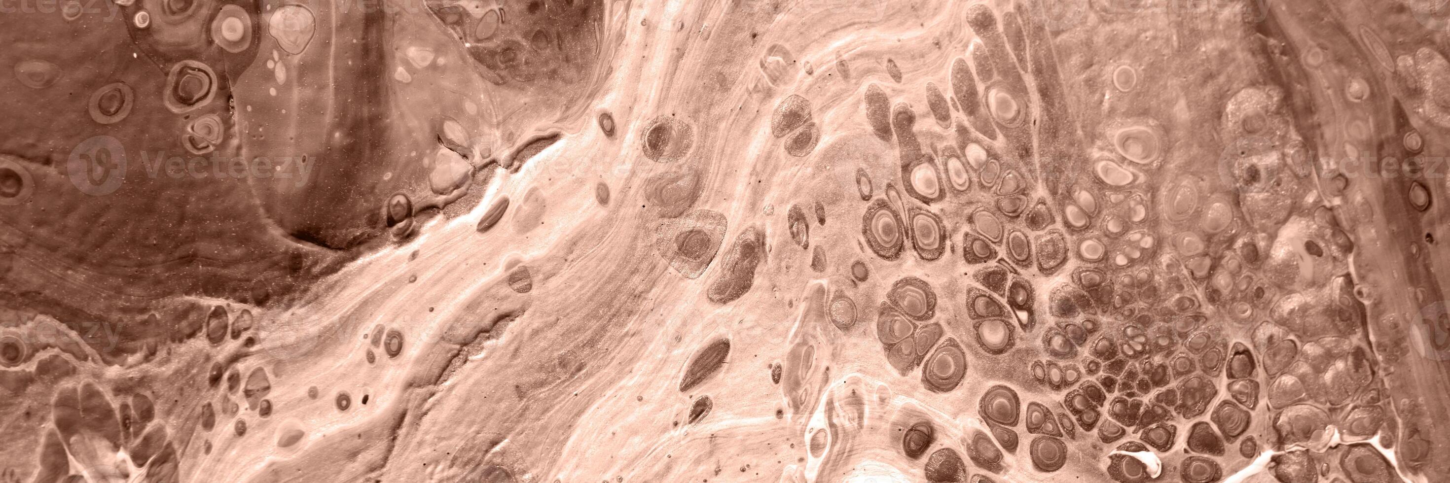 The texture of marble. Abstract background, made in the technique of fluid art. Demonstrating the colors of 2025 - Mocha Mousse photo