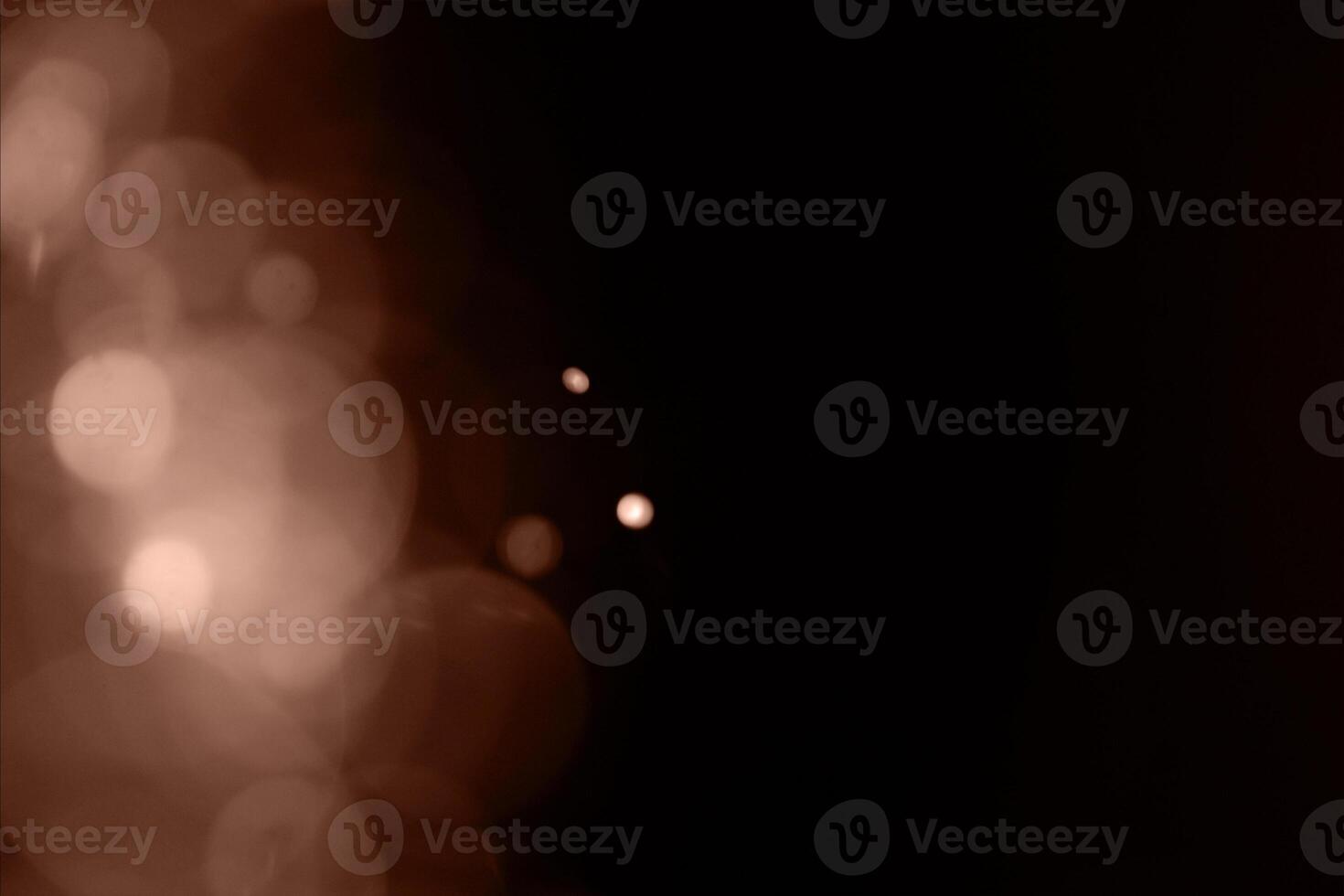 Blurry garland lights on a dark background. Festive Christmas and New Year background. Soft focus. Image toned in color of 2025 year - Mocha Mousse photo