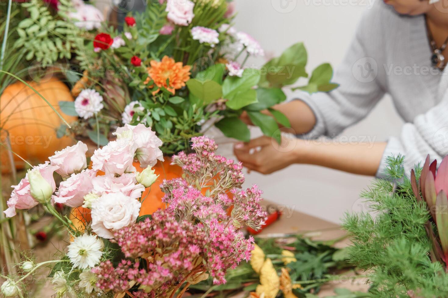 Creating a floral composition in a pumpkin. Making decor with your own hands. photo