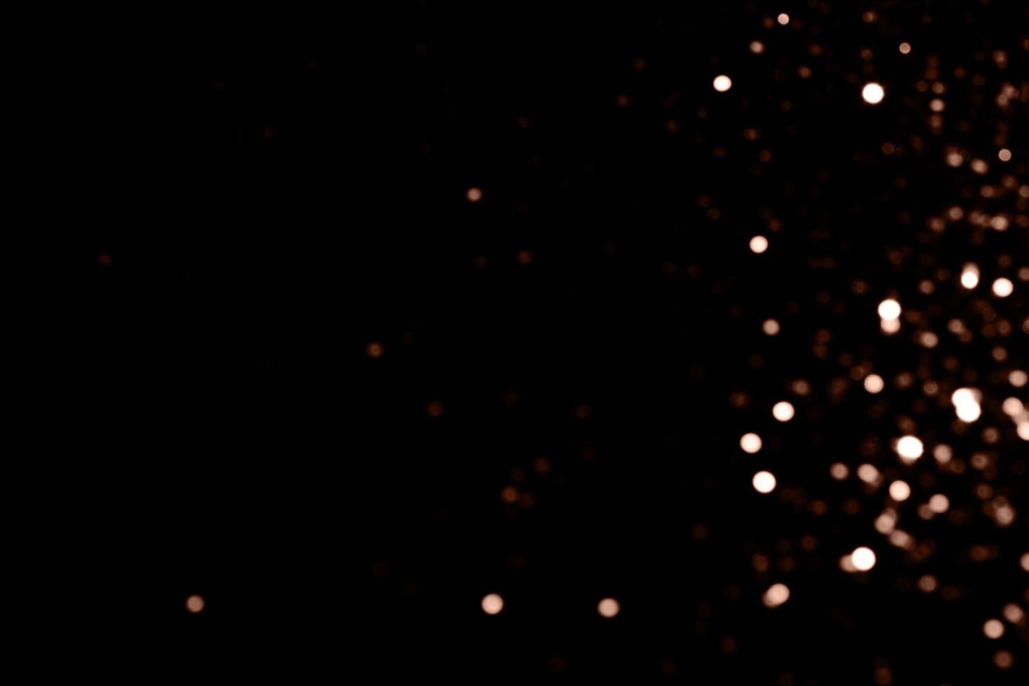Blurry garland lights on a dark background. Festive Christmas and New Year background. Soft focus. Image toned in color of 2025 year - Mocha Mousse photo