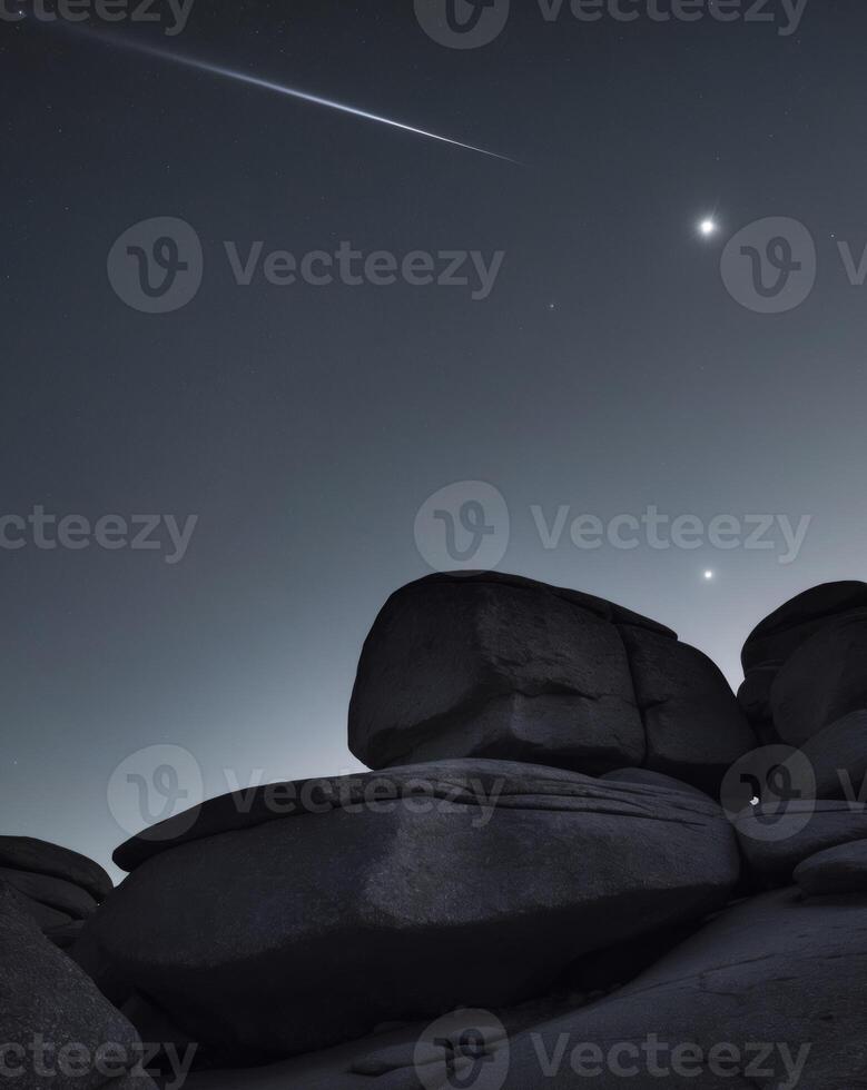 A comet and a rock formation in the night sky photo