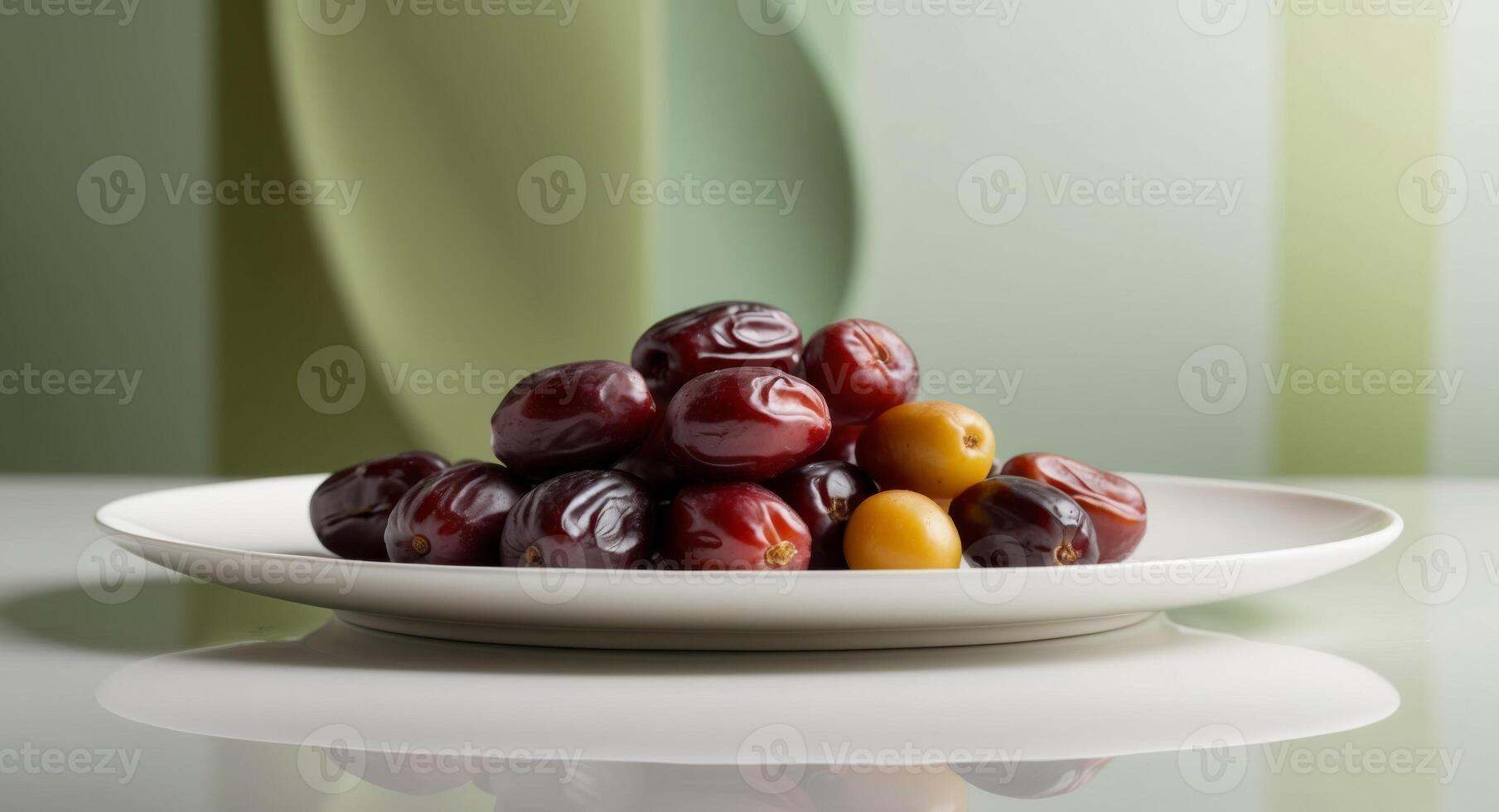 A plate of dates and olives on a table photo