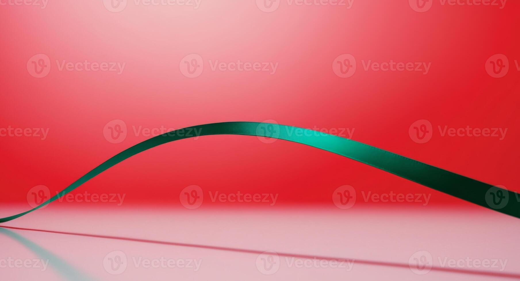 A curved green ribbon on a red background photo
