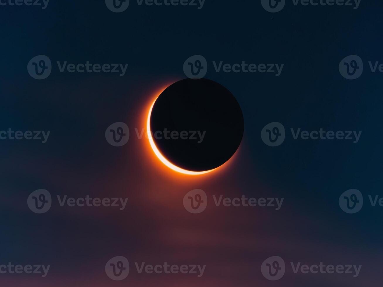 The eclipse is seen through the clouds photo