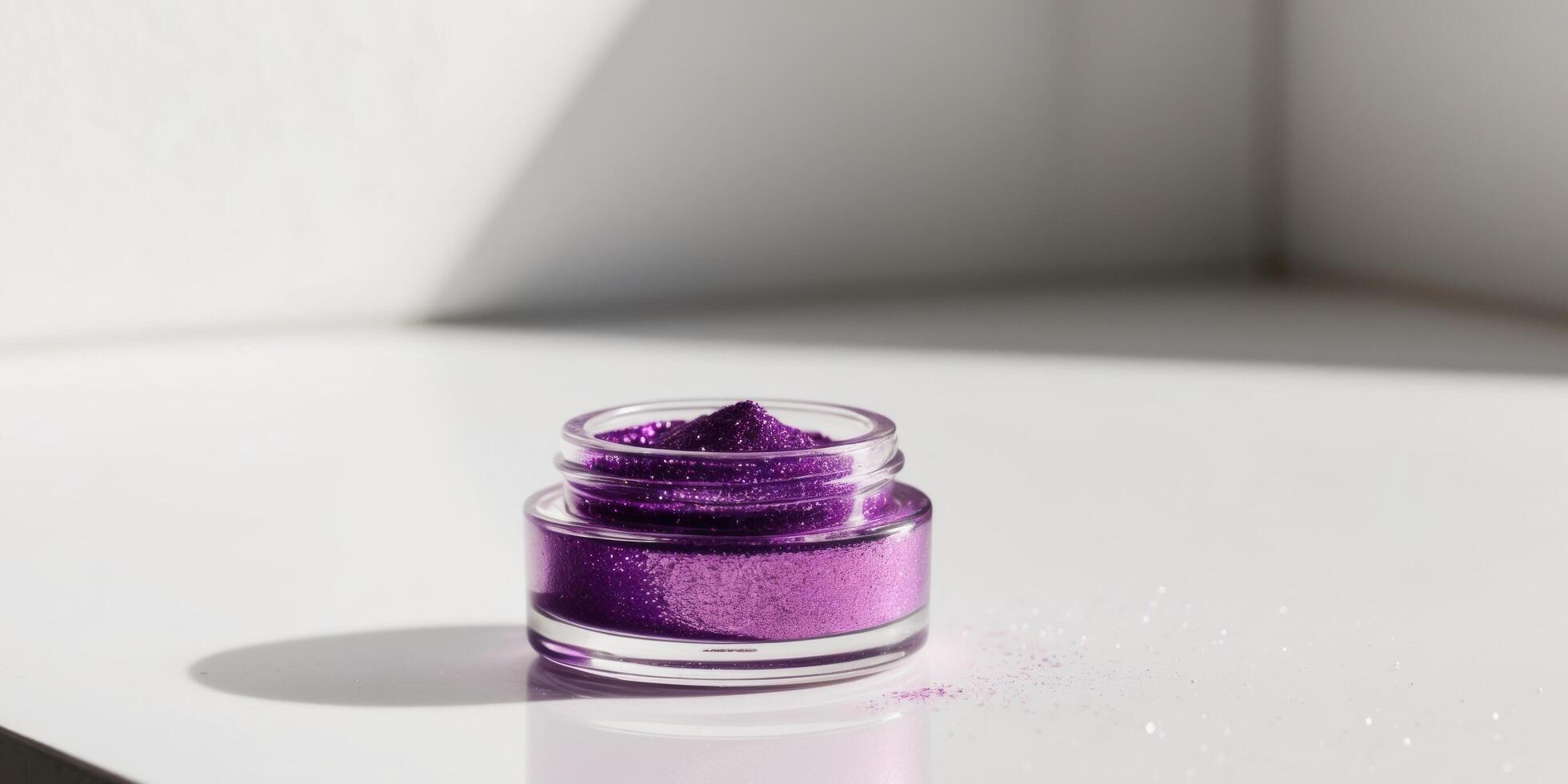 A purple powder in a glass jar on a white surface photo