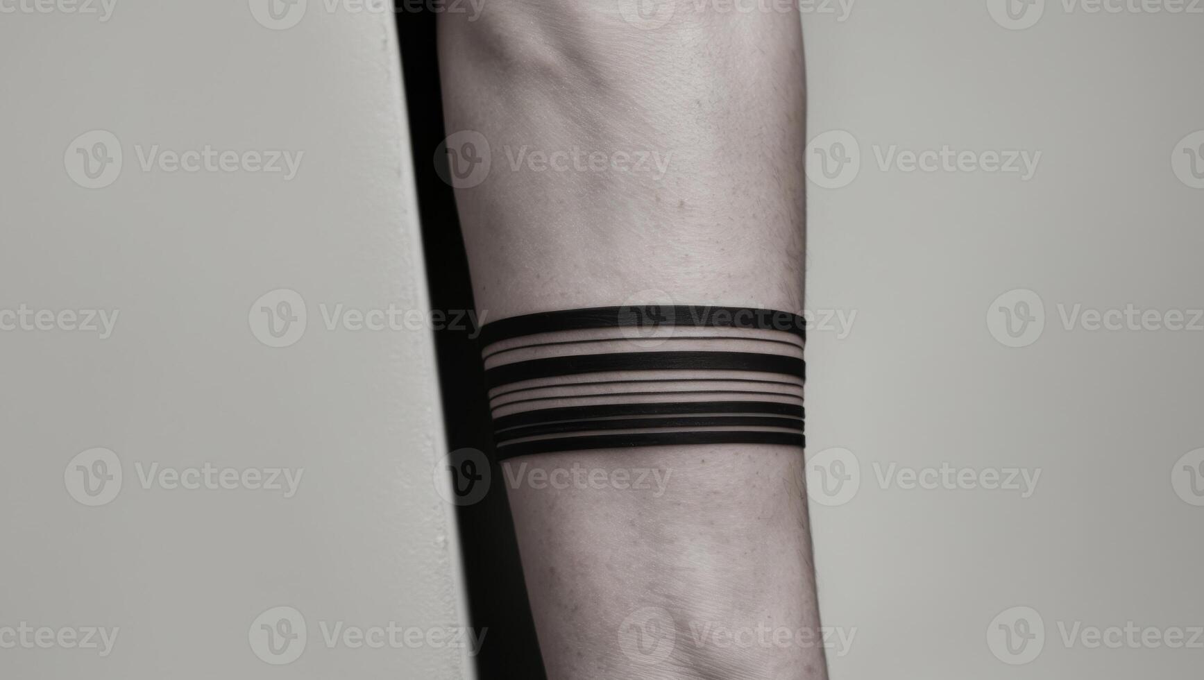 A black and white photo of a wrist with a black strip