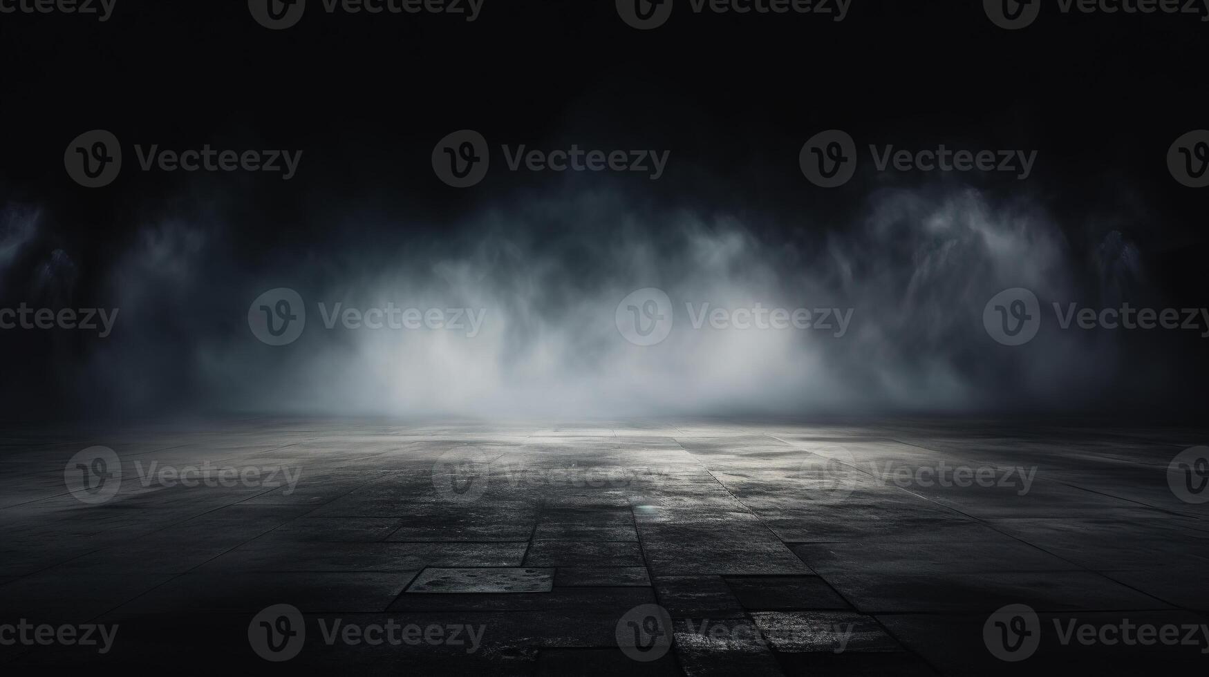 An empty room with a dark floor and a light coming from the ceiling photo