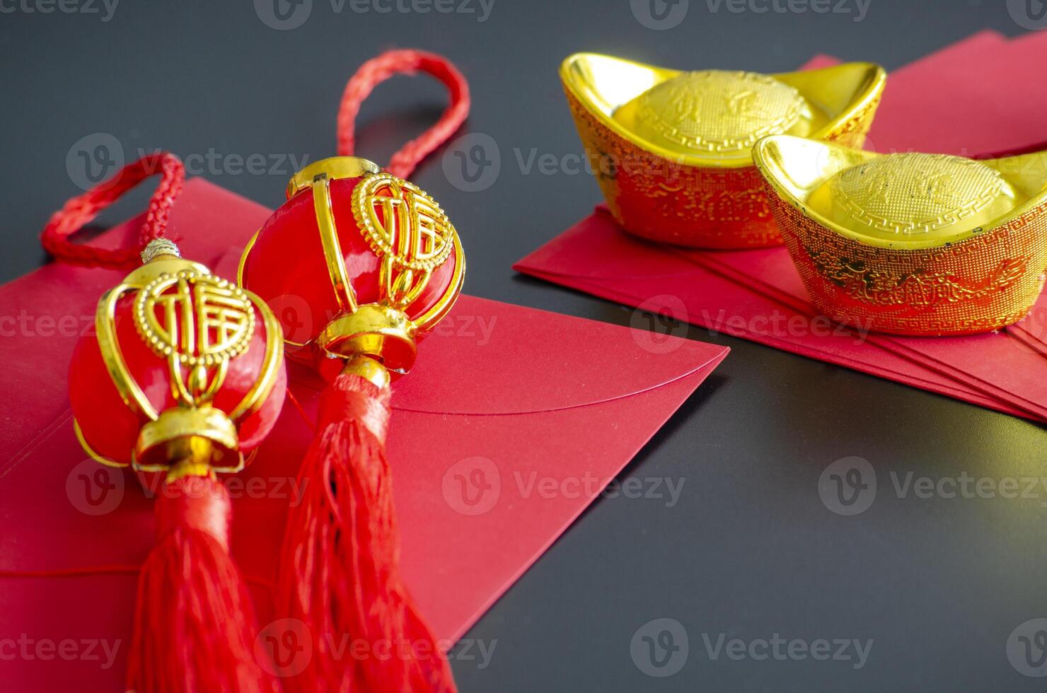 Chinese New Year decoration with golden ingots and Chinese New Year balls on red packets photo