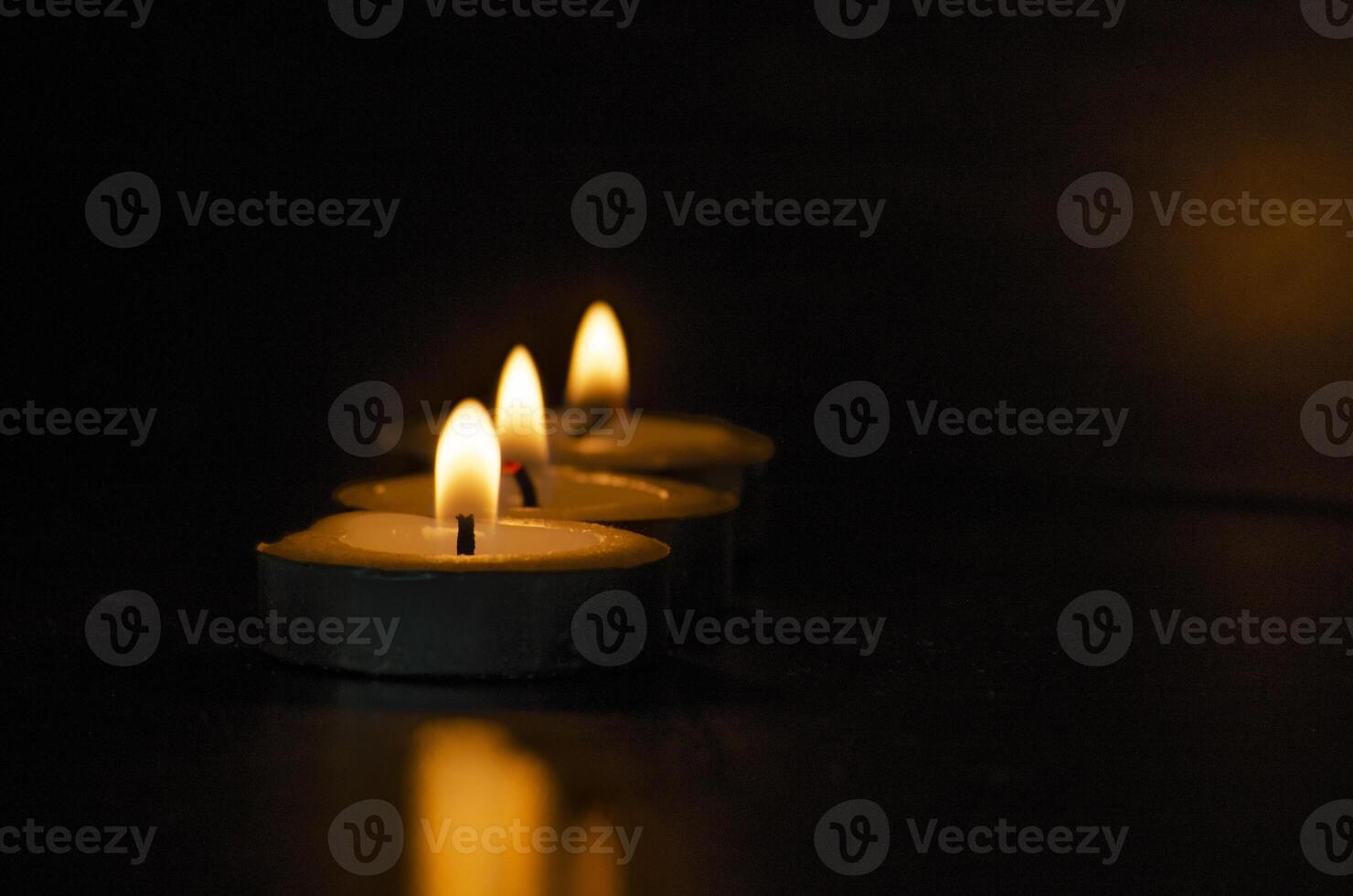 Candles shining in the dark with customizable space for message, text or ideas. Copy space and candles concept photo