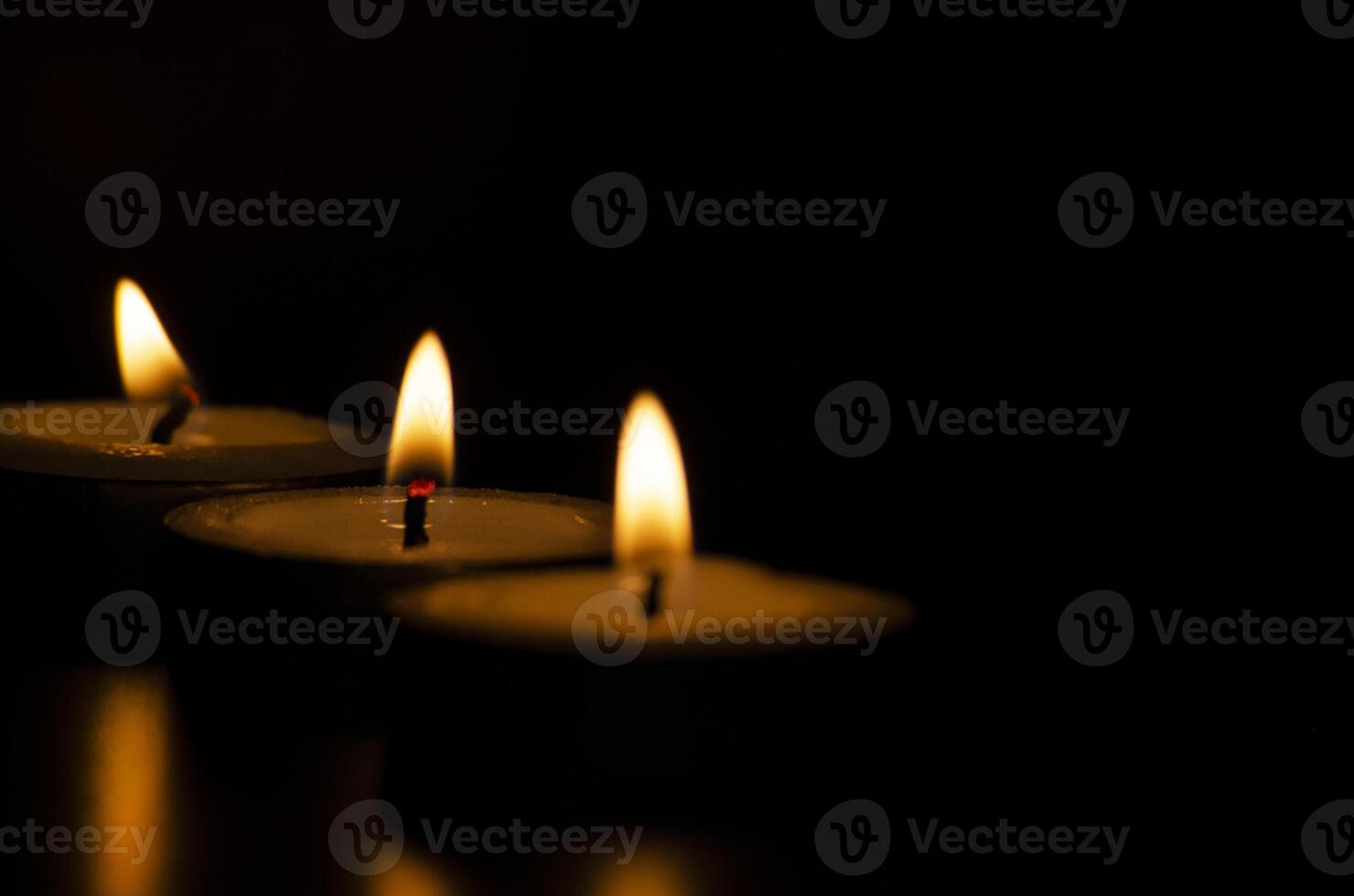 Candles shining in the dark with customizable space for message, text or ideas. photo