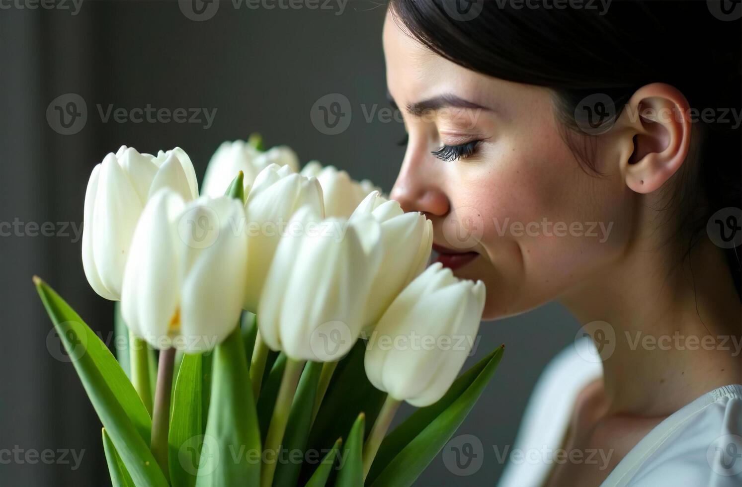 Woman sniffing bouquet of white tulips female flower flavor photo
