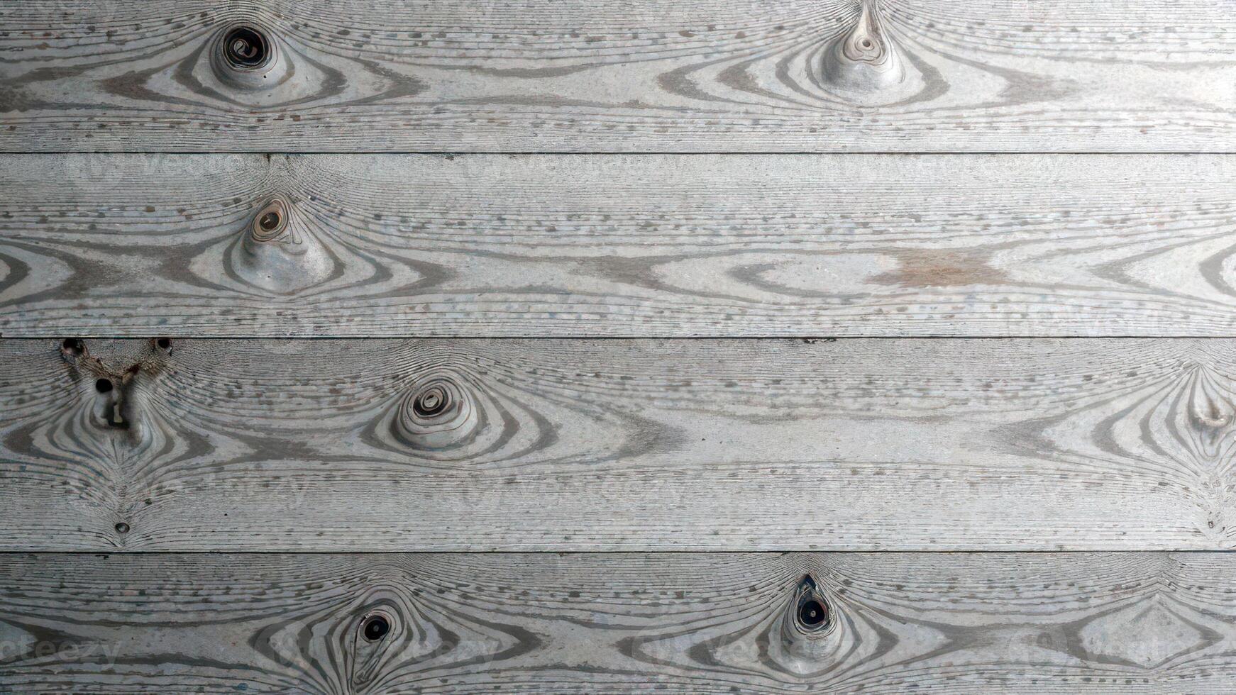 Textured wooden planks with knots and grain patterns in weathered gray tones photo