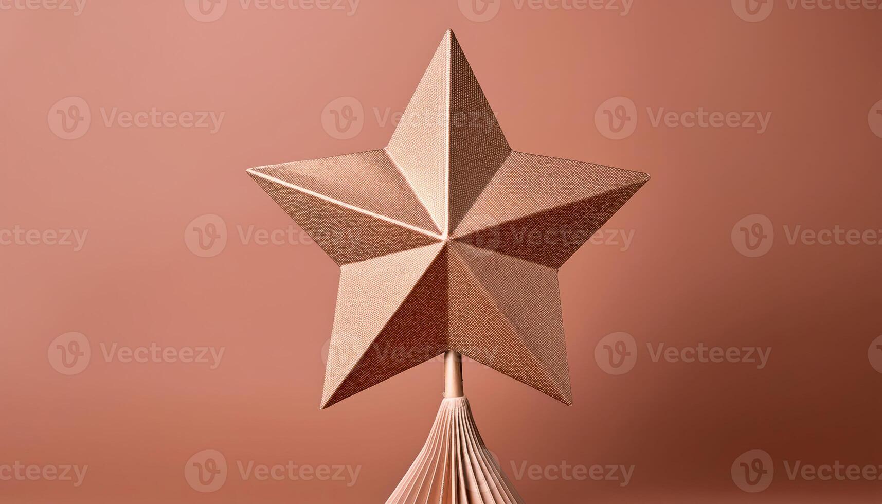 Geometric bronze star on peach background with folding base photo