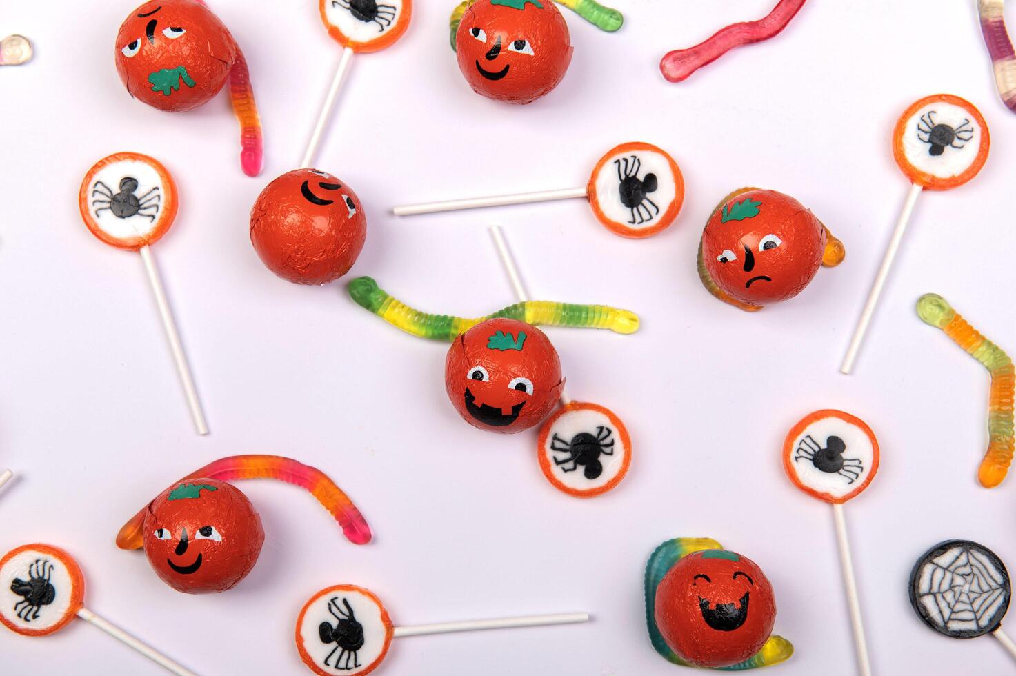 Halloween candy with black spiders on white background photo