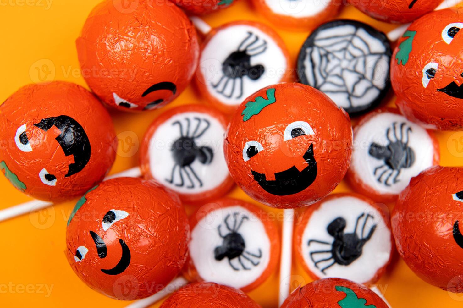 Halloween candy with black spiders and cobweb photo