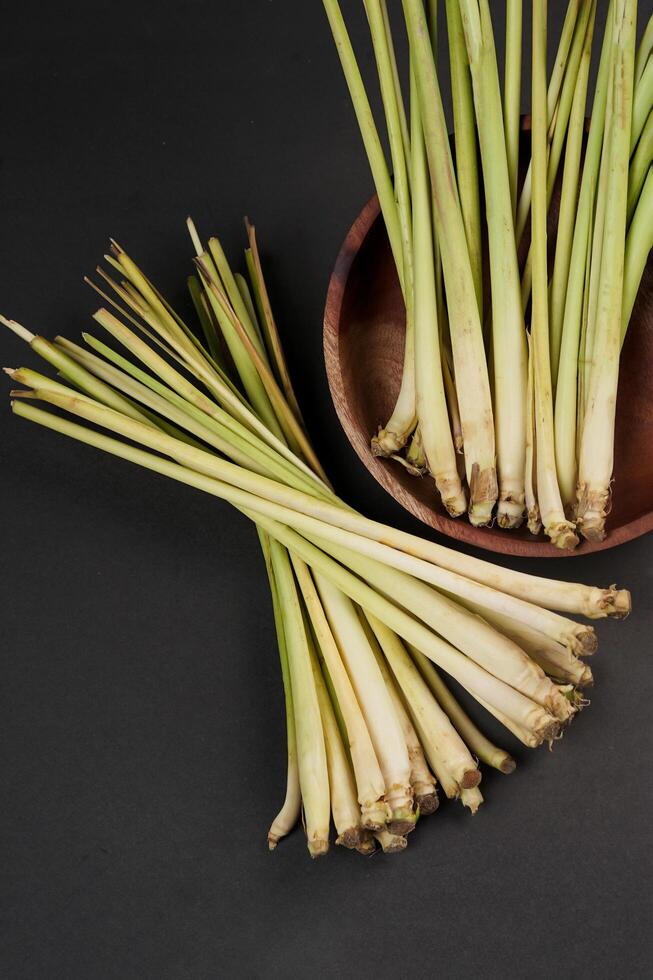 Lemon grass on wooden bowl isolated on black background, high resolution photo. photo