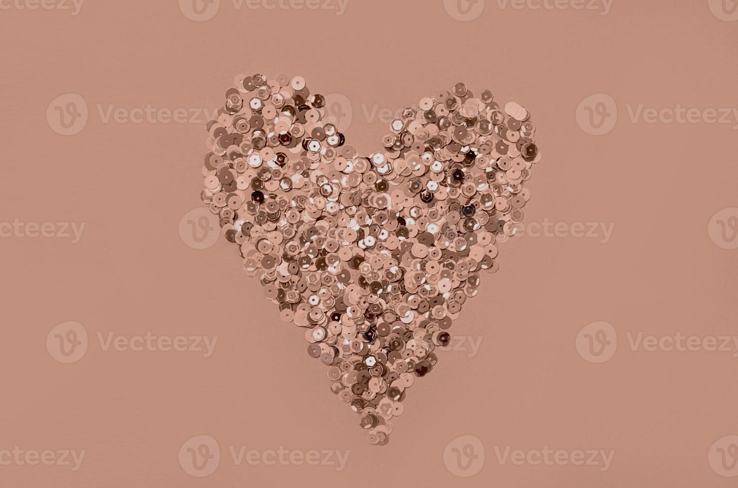 Elegant rose gold heart shaped from glittering sequins on soft background photo