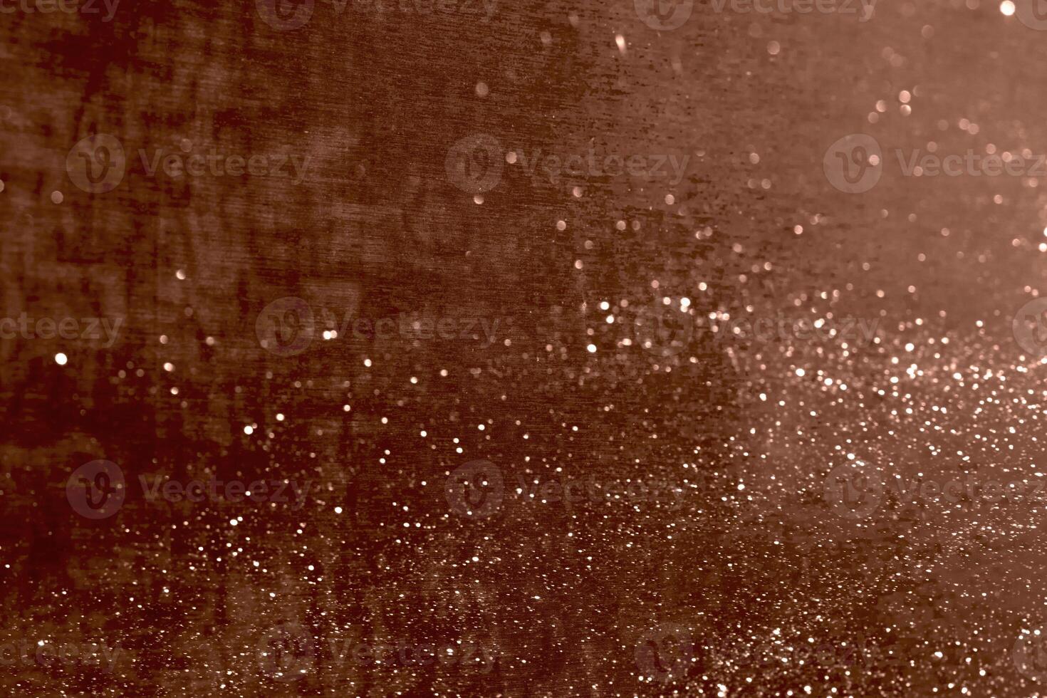 Glittering abstract texture with brown background and sparkling particles photo