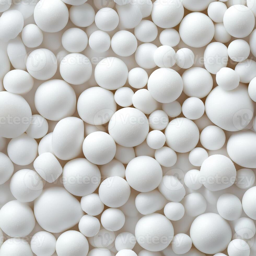 A large group of white balls of different sizes and shapes photo