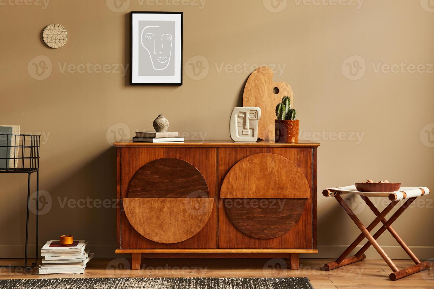 Stylish interior with design wooden commode, stool, cacti in pot, unique decoration, carpet, mock up poster frame and elegant personal accessories. Modern living room in classic house. photo