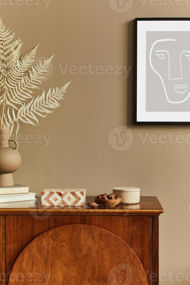 Interior design of unique living room with stylish commode, dired flowers in vase, mock up poster on the wall, decoration and personal accessories in modern home decor. Template. photo