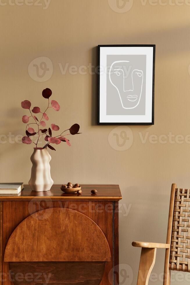 Interior design of unique living room with stylish commode, armchair, dired flowers in vase, mock up poster on the wall, decoration and personal accessories in modern home decor. Template. photo