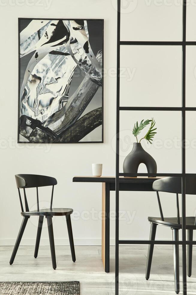 Stylish scandinavian living room interior of modern apartment with wooden design table, chairs, carpet, leaf in vase, abstract paintings on the wall and personal accessories in unique home decor. photo