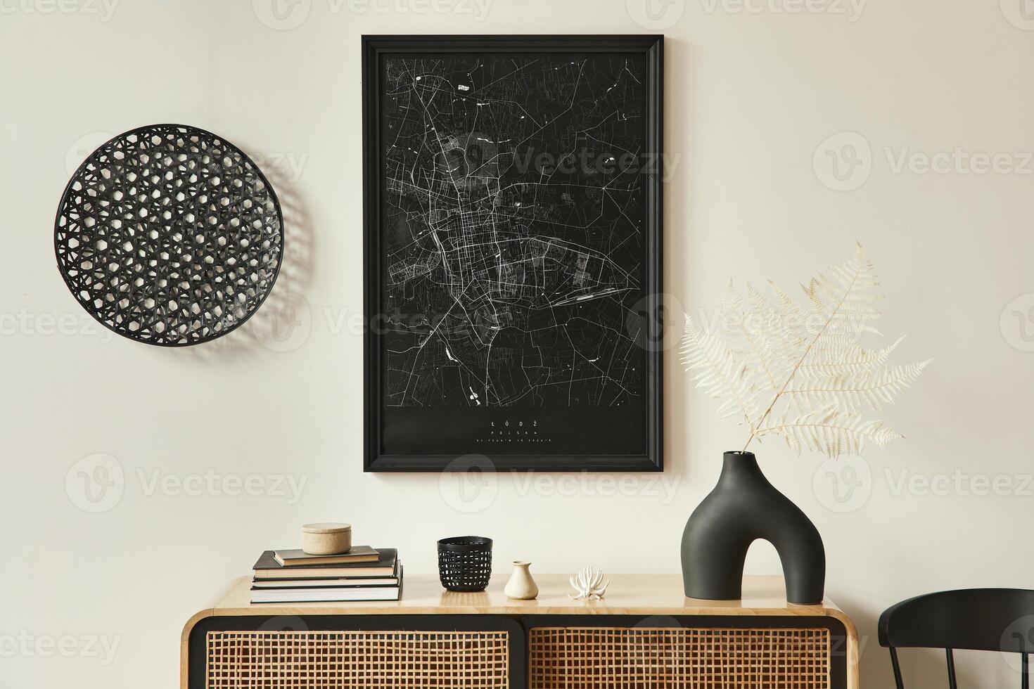 Minimalist composition of living room interior with black mock up poster map, wooden commode, black round decoration, leaf in vases and elegant personal accessories. Template. photo
