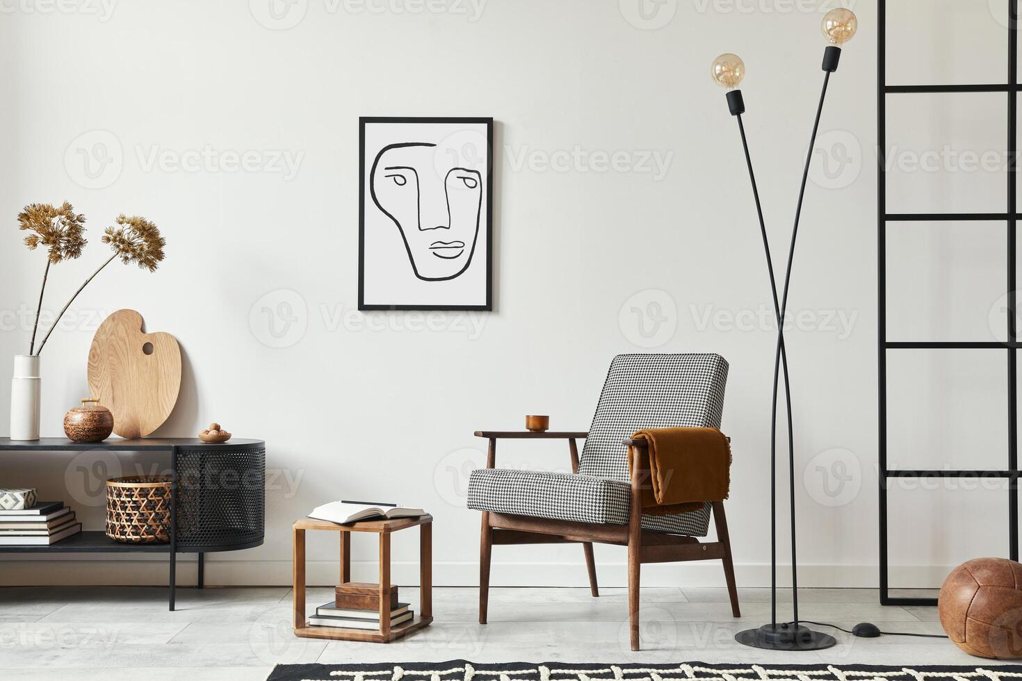 Stylish scandinavian composition of living room with design armchair, black mock up poster frame, commode, wooden stool, lamp, decoration, loft wall and personal accessories in modern home decor. photo
