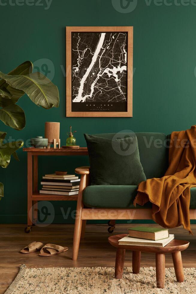 Stylish living room in house with modern retro interior design, velvet sofa, carpet on floor, brown wooden furniture, plants, poster mock up map, book, lamp and perosnal accessories in home decor. photo
