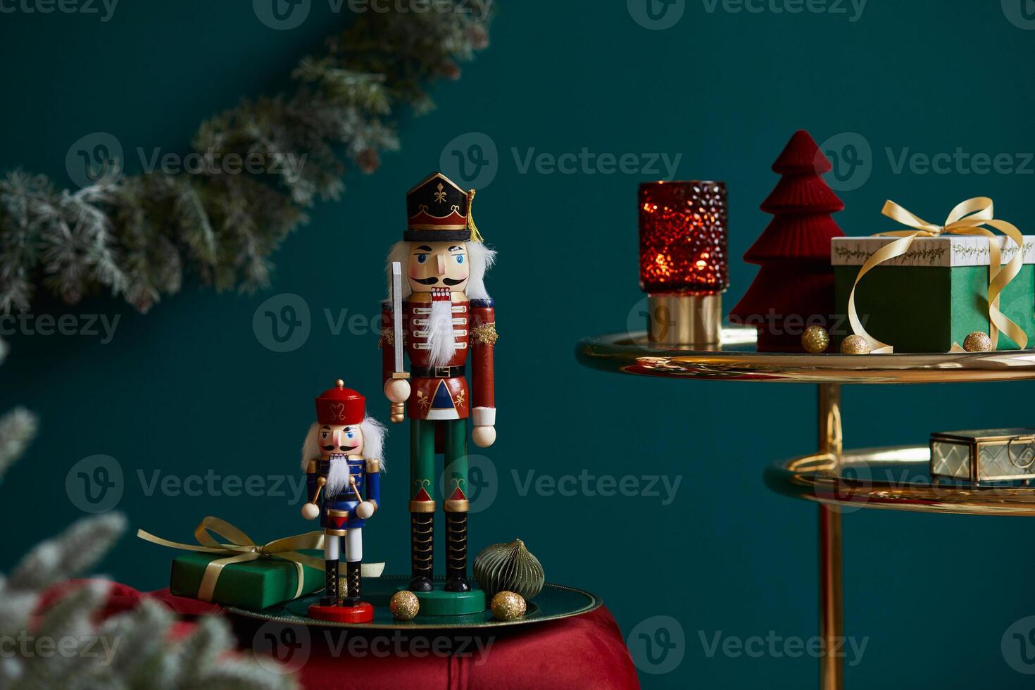 Christmas composition on the red velvet bench with decoration, gifts, wreath, nutcracker and accessories. Copy space. Red and green color. Template. photo