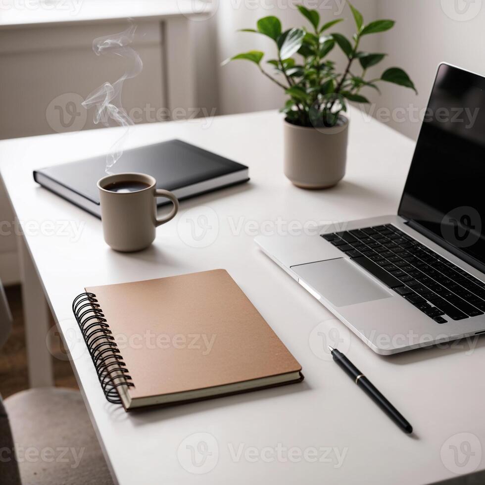 Minimalist workspace with laptop, notebook, and coffee cup photo