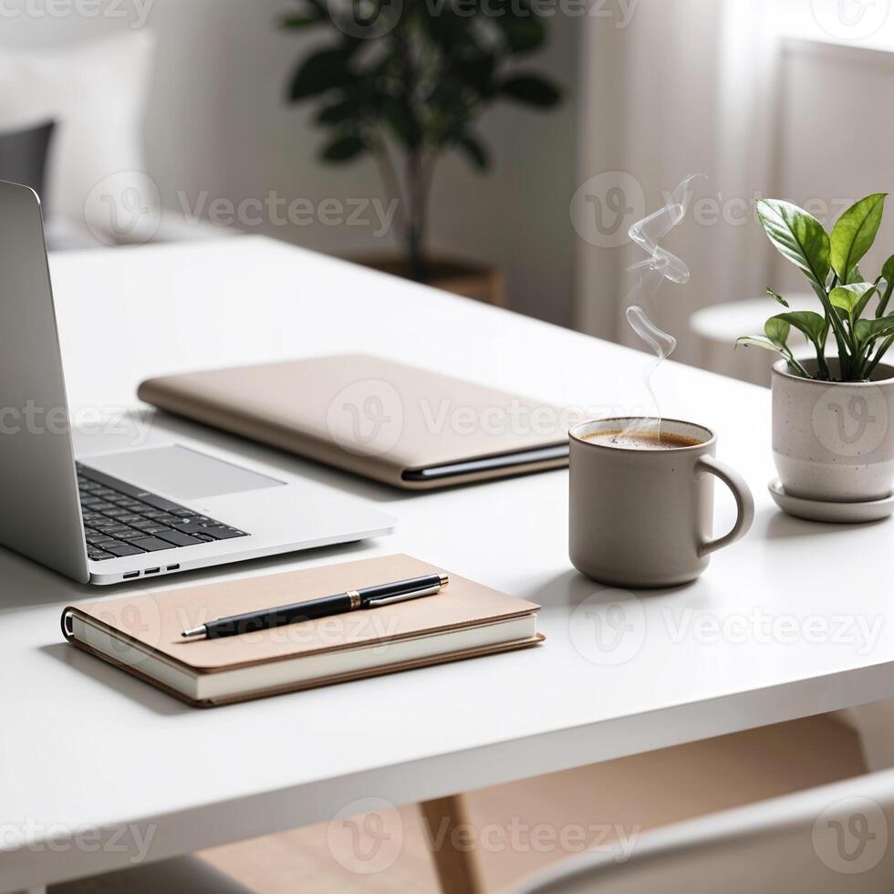 Minimalist workspace with laptop, notebook, and coffee cup photo