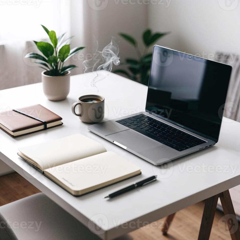 Minimalist workspace with laptop, notebook, and coffee cup photo