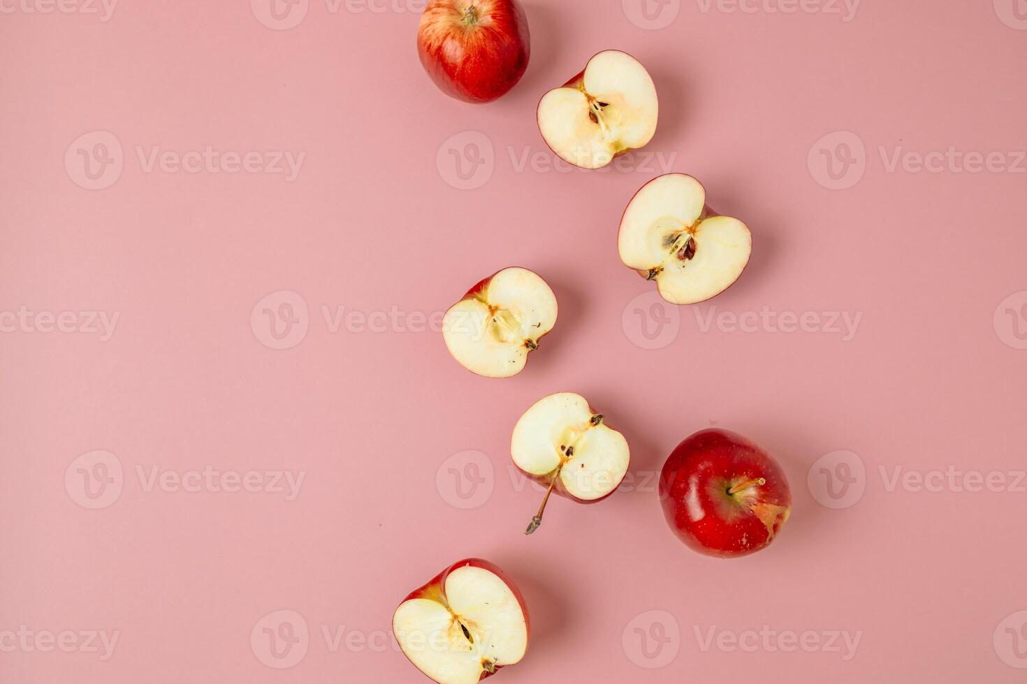 Red apple, half apple and quarter apple on pink background. Top view, healthy food concept. Top view. photo